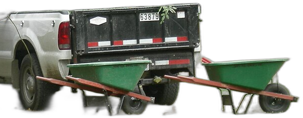 Evergreen work truck loaded with brush beside two wheelbarrows